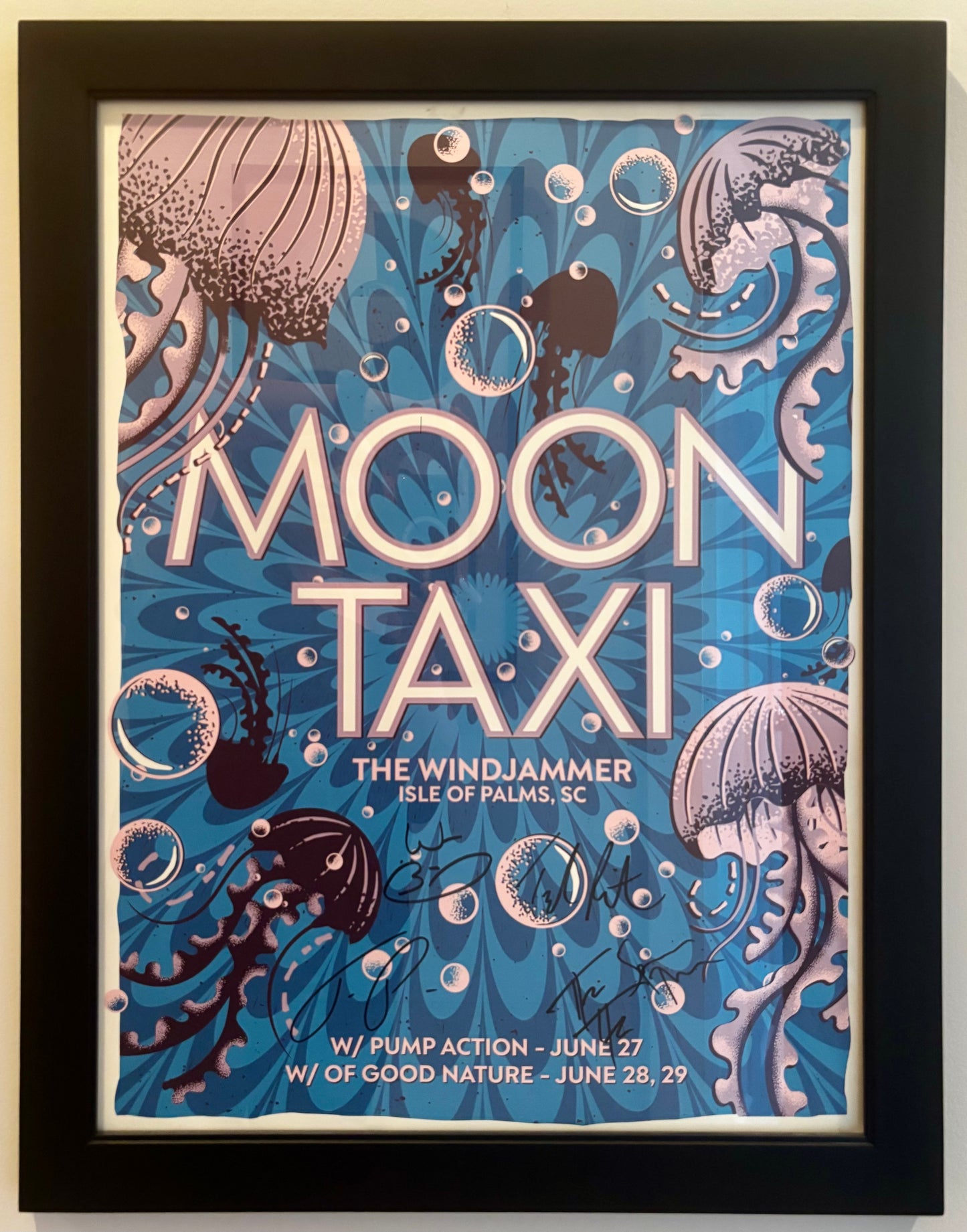 Framed poster for 'Moon Taxi' event with underwater-themed design and text.